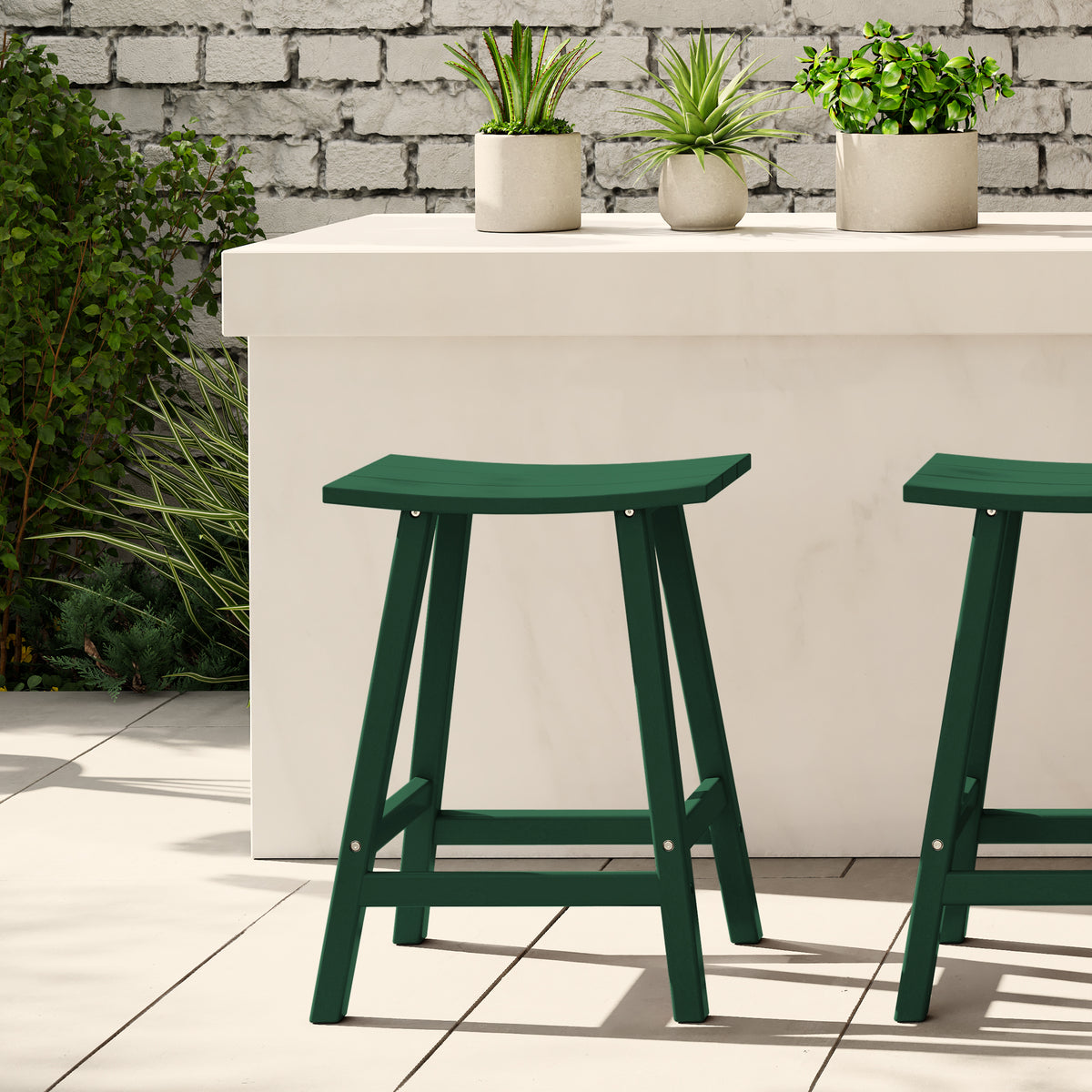Malibu 24 inch counter height bar stool in Dark Green styled outdoors