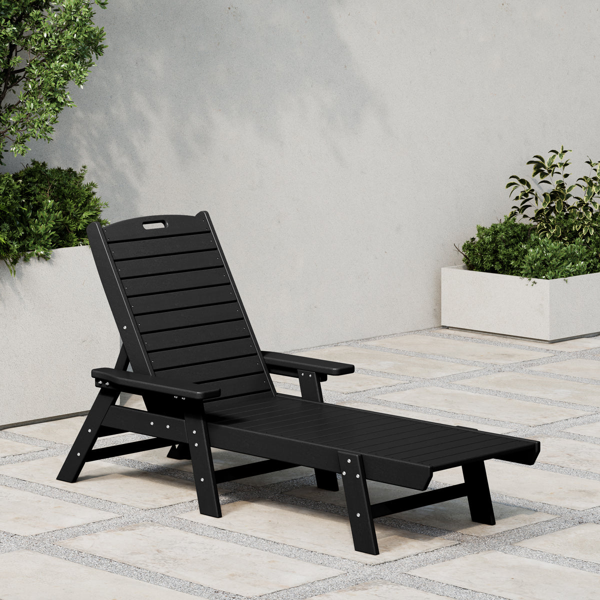 Malibu reclining chaise lounge in Black styled outdoors